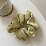 Soft, elastic hair scrunchie, perfect for holding hair securely without causing damage, suitable for all hair types.