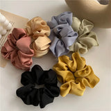 Soft, elastic hair scrunchie, perfect for holding hair securely without causing damage, suitable for all hair types.