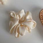 Soft, elastic hair scrunchie, perfect for holding hair securely without causing damage, suitable for all hair types.