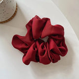 Soft, elastic hair scrunchie, perfect for holding hair securely without causing damage, suitable for all hair types.