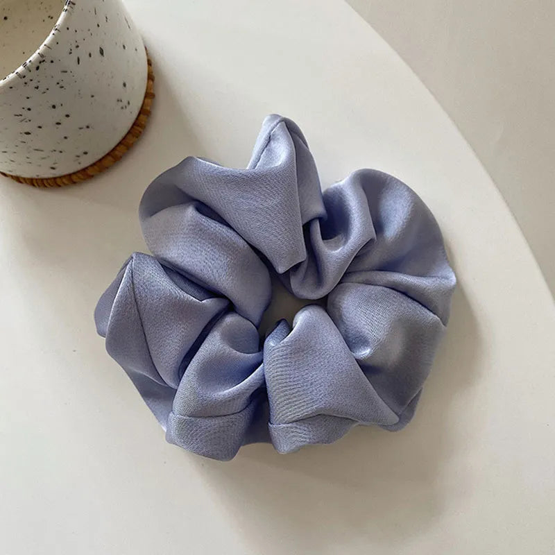 Soft, elastic hair scrunchie, perfect for holding hair securely without causing damage, suitable for all hair types.