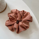 Soft, elastic hair scrunchie, perfect for holding hair securely without causing damage, suitable for all hair types.