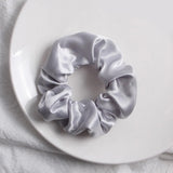 Soft, elastic hair scrunchie, perfect for holding hair securely without causing damage, suitable for all hair types.