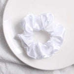 Soft, elastic hair scrunchie, perfect for holding hair securely without causing damage, suitable for all hair types.