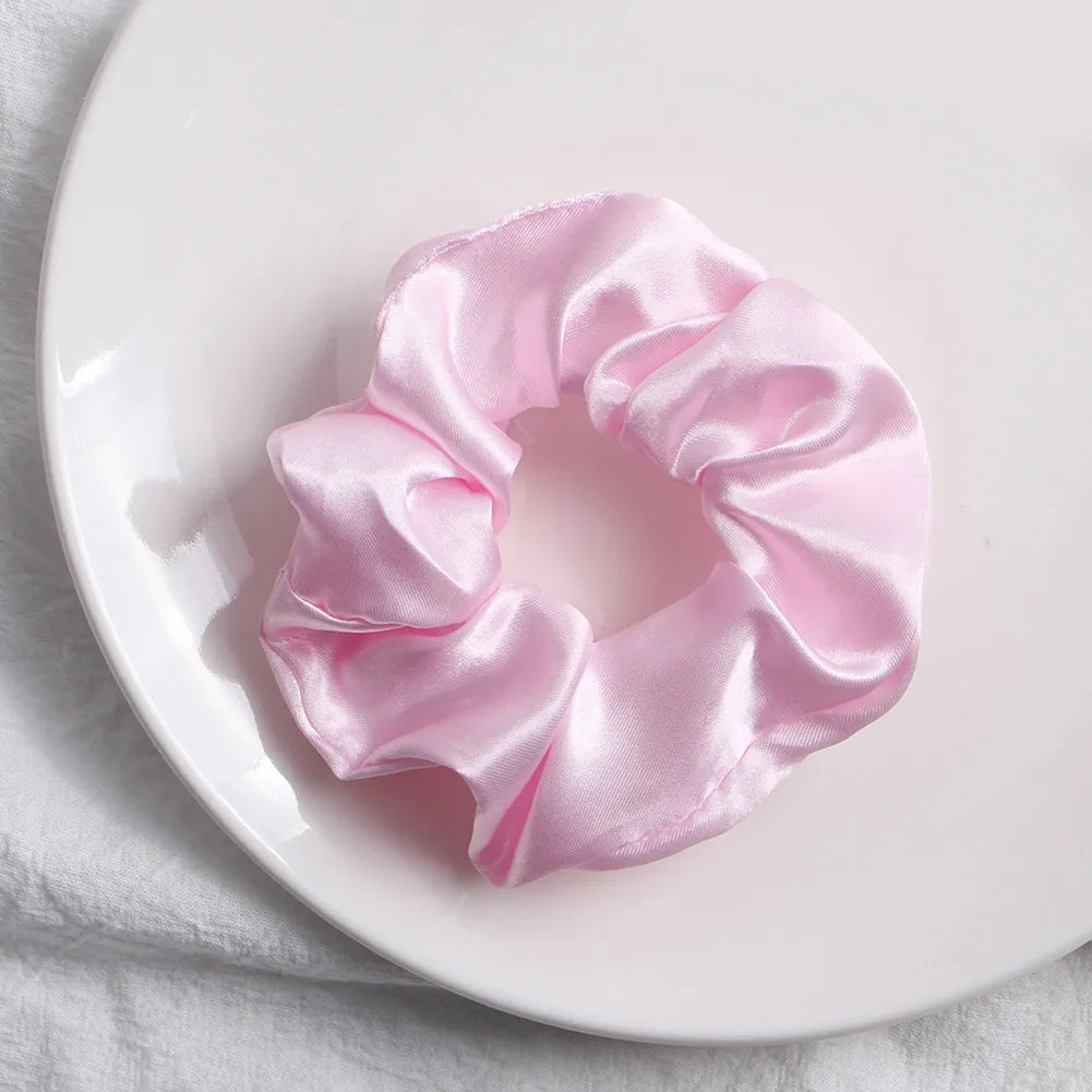 Soft, elastic hair scrunchie, perfect for holding hair securely without causing damage, suitable for all hair types.