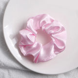 Soft, elastic hair scrunchie, perfect for holding hair securely without causing damage, suitable for all hair types.