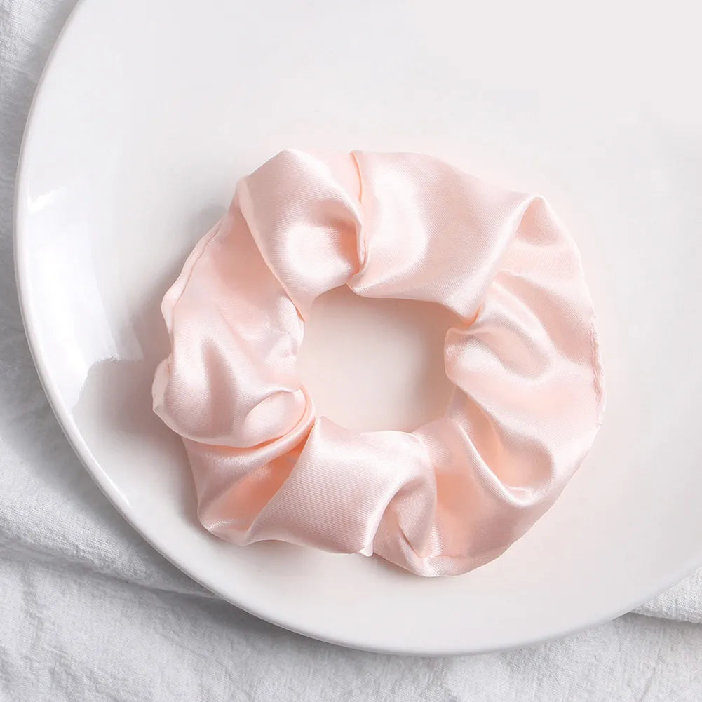 Soft, elastic hair scrunchie, perfect for holding hair securely without causing damage, suitable for all hair types.