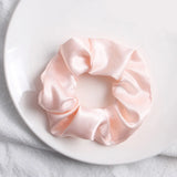 Soft, elastic hair scrunchie, perfect for holding hair securely without causing damage, suitable for all hair types.