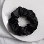 Soft, elastic hair scrunchie, perfect for holding hair securely without causing damage, suitable for all hair types.